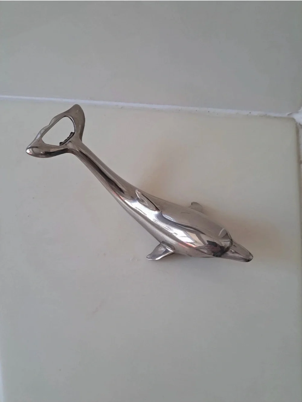 Sleek silver-plated Dolphin bottle opener